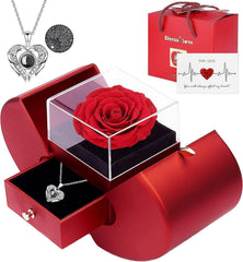 A red gift box containing a preserved rose and a heart-shaped necklace with a projection stone.
