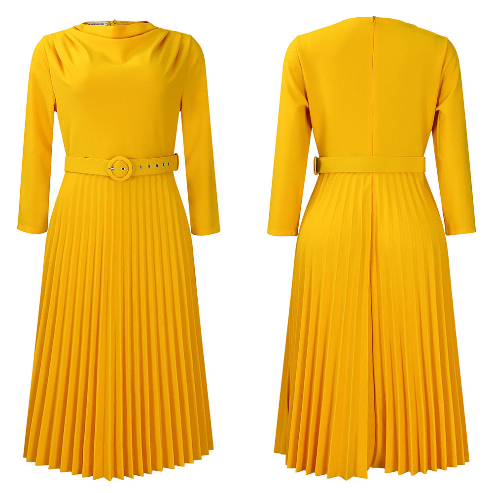 A yellow midi dress with a crewneck, three-quarter sleeves, a pleated skirt, and a matching belt.