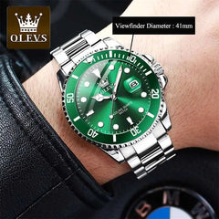 A person wears a black leather sleeve and an OLEVS Mens Quartz Watch—top brand luxury, waterproof, luminous, with a silver case, green bezel and dial, large hour markers, date window, stainless steel band, and a 41mm viewfinder.