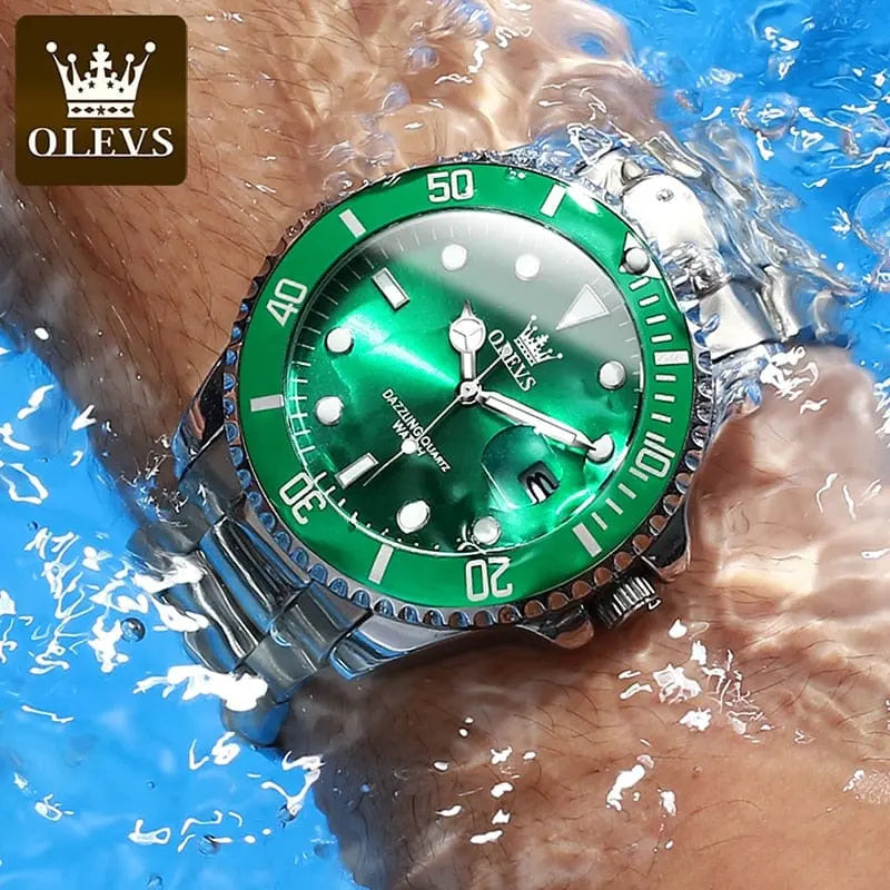 An OLEVS Mens Quartz Luxury Business Waterproof Watch with a green bezel and dial is worn underwater, highlighting the stainless steel sports timepiece’s impressive water resistance and luminous large dial.