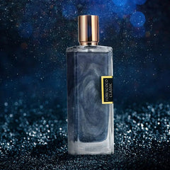 A rectangular glass perfume bottle with a gold cap and shimmering dark blue liquid inside.