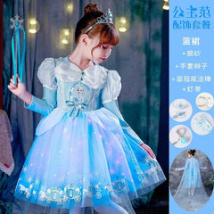 A young girl wears a light blue Elsa-themed princess dress with a matching crown and wand.