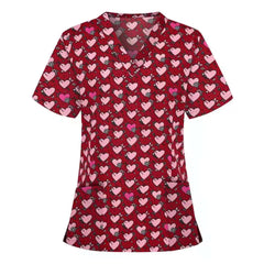 Red V-neck scrub top featuring a repeating pattern of pink hearts and small floral accents.