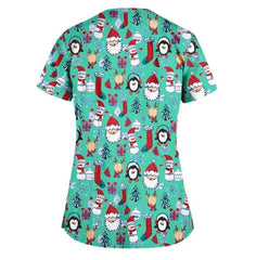 Green scrub top featuring a festive Christmas pattern of Santa, reindeer, penguins, and gifts.