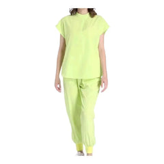 A person wearing a lime green medical scrub set with a short-sleeved top and jogger-style pants.