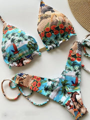 A bikini set featuring a vibrant tropical print with animals, palm trees, and flowers.