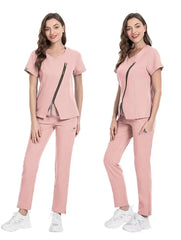 A woman models a pink, stretchy, short-sleeved scrub set featuring a diagonal front zipper.