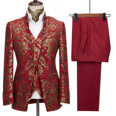 A three-piece men's suit featuring a red and gold floral jacquard blazer, vest, and solid pants.