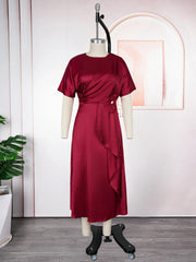 A burgundy satin midi dress with short sleeves, a draped bodice, and a floral waist accent.