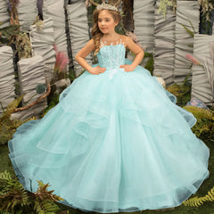 A girl wears a light blue sleeveless ball gown with floral appliques and a tiered tulle skirt.