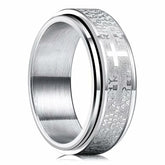 A silver stainless steel spinner ring featuring an engraved Christian cross and prayer text.