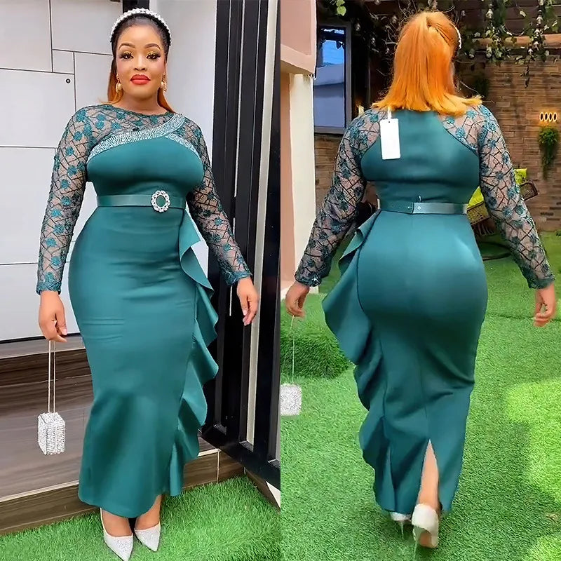 A woman wears a long-sleeved teal dress with lace sleeves, a belted waist, and a ruffled side.