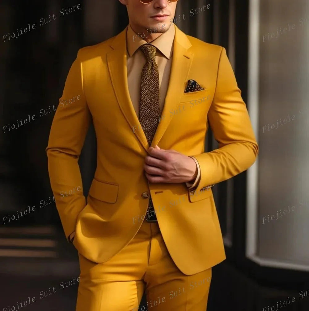 A man wears a mustard yellow two-piece suit with a brown shirt and tie.