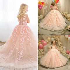 A pink sleeveless ball gown for girls featuring floral lace appliques and a tulle skirt.