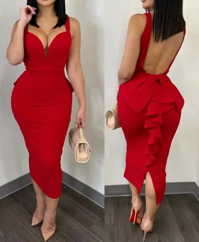 A woman wears a red, mid-calf sheath dress with a sweetheart neckline and a ruffled back detail.