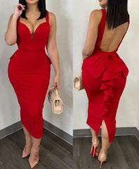 A woman wears a red, mid-calf sheath dress with a sweetheart neckline and a ruffled back detail.