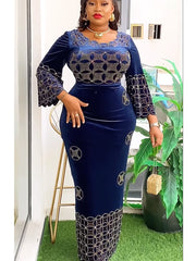 A woman wears a navy blue velvet maxi dress featuring intricate gold circular embellishments.