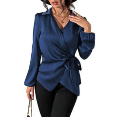 A navy blue long-sleeve wrap blouse with a tie waist and a collared neckline.