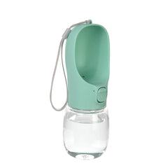 A mint green portable pet water bottle with a built-in drinking bowl and a carrying strap.