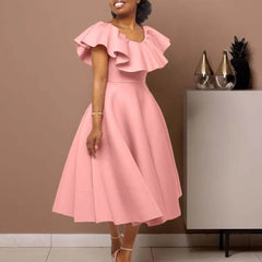 A woman wears a pink mid-calf A-line dress with a round neckline and ruffled butterfly sleeves.