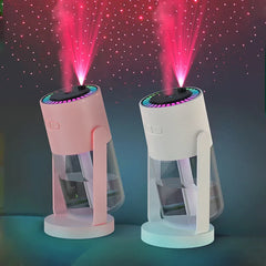 Two portable rotating humidifiers in pink and white with integrated projection night lights.