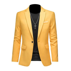 A yellow single-breasted blazer for men with a black shirt and a silver pendant necklace.
