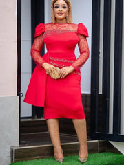 A woman wears a red midi sheath dress with lace sleeves, puff shoulders, and beaded embellishments.