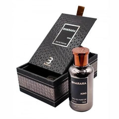 A bottle of Bharara King eau de parfum stands next to its open, textured black presentation box.
