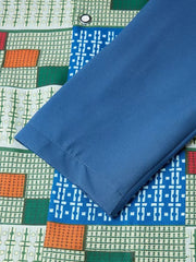 A close-up of a blue long-sleeved shirt featuring a geometric pattern in orange, green, and white.