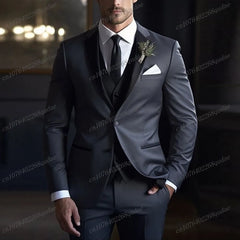 A man wears a charcoal grey three-piece suit with a black collar, white shirt, and black tie.