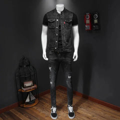 A black denim vest with a stand collar and button-down front worn over a black t-shirt.
