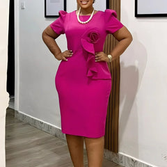 A fuchsia sheath dress with short puff sleeves and a decorative fabric rose on the bodice.