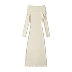 A white, off-shoulder, long-sleeved knit maternity dress in a slim-fit, ankle-length style.