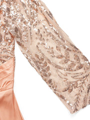 A close-up of a rose gold evening dress sleeve featuring intricate sequin embroidery on sheer mesh.