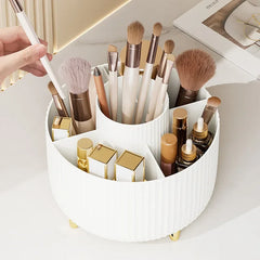 A white, circular, rotating desktop organizer with five compartments holding makeup brushes.