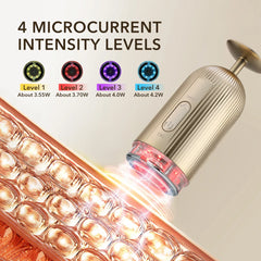 A gold handheld electric facial massager with four intensity levels and a glowing red light.