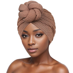 A woman wears a brown, textured bubble cloth turban featuring a large decorative knot on top.
