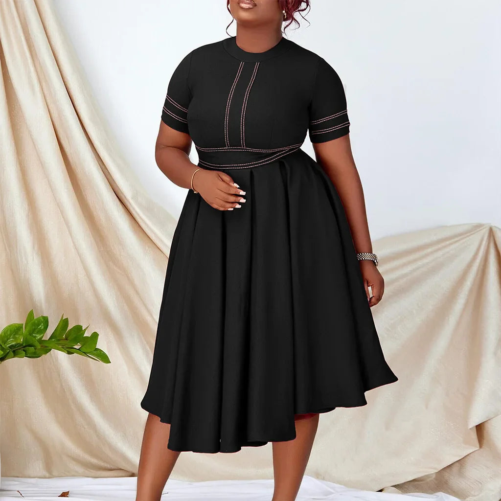 A black short-sleeved A-line dress with contrast stitching and a pleated skirt.