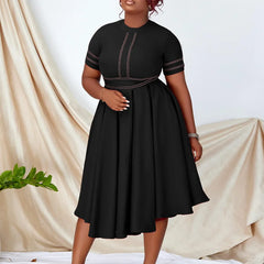 A black short-sleeved A-line dress with contrast stitching and a pleated skirt.