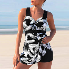 A woman wears a black and white patterned tankini swimdress with a matching swim short bottom.