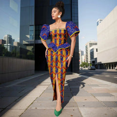 A woman wears an ankle-length Ankara print dress with a square neckline and puff sleeves.