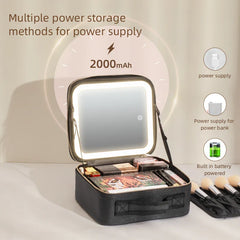 A black makeup travel case with an integrated LED mirror and internal storage compartments.