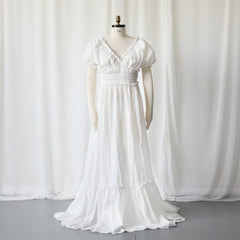 A white bohemian maternity maxi dress with a V-neck, ruffled sleeves, and a smocked waist.
