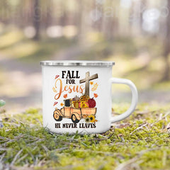A white enamel camping mug featuring a fall-themed graphic of a truck, pumpkins, and a cross.