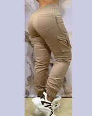 A pair of beige cargo pants with a chain detail, side pockets, and cuffed ankles.