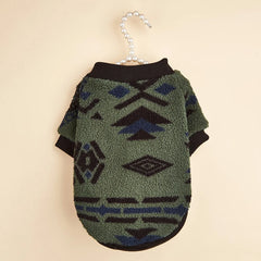 A green fleece dog sweater featuring a black and blue geometric totem print.