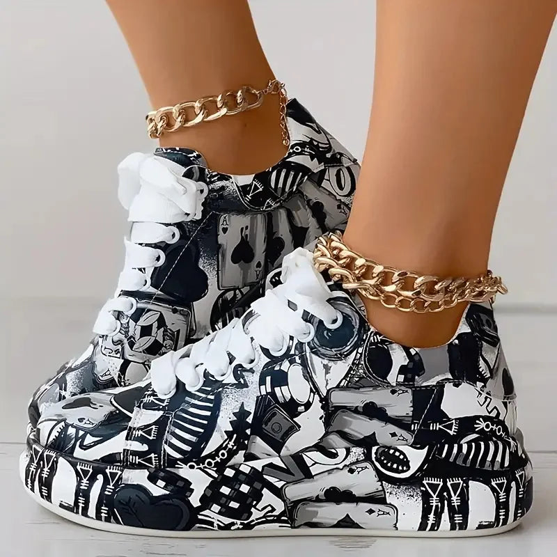 Women's thick-soled sneakers featuring a black and white graffiti print with playing card motifs.