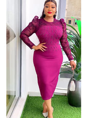 A woman wears a magenta midi dress with sheer lace sleeves and beaded bodice detailing.