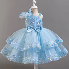 A light blue sleeveless ball gown dress with sequins, a large bow, and tiered tulle skirt.