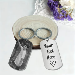 Two metal dog tag keychains, one featuring a photo of a boy and the other with custom text.
